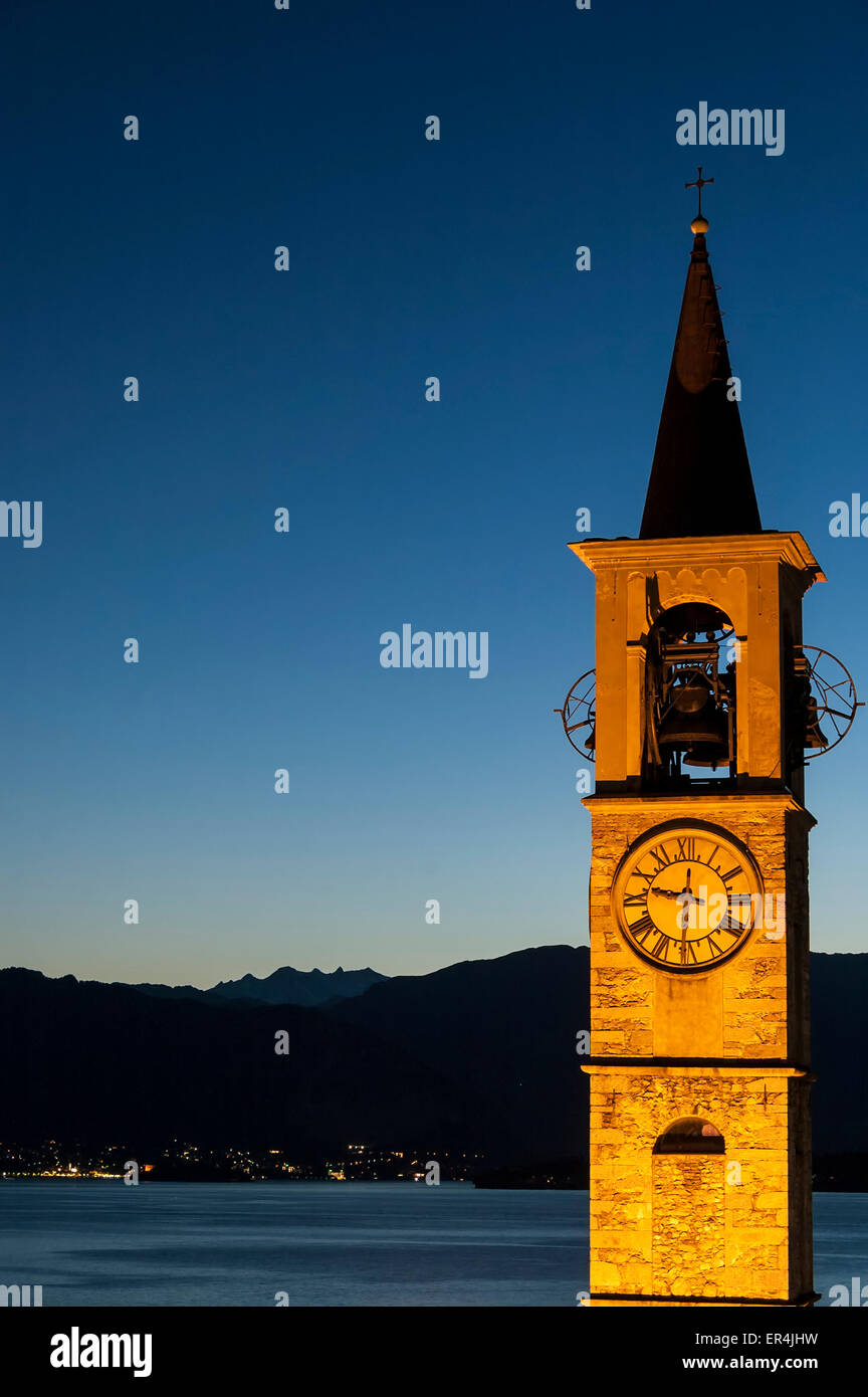 bell tower illuminated with background mountains and sky Stock Photo
