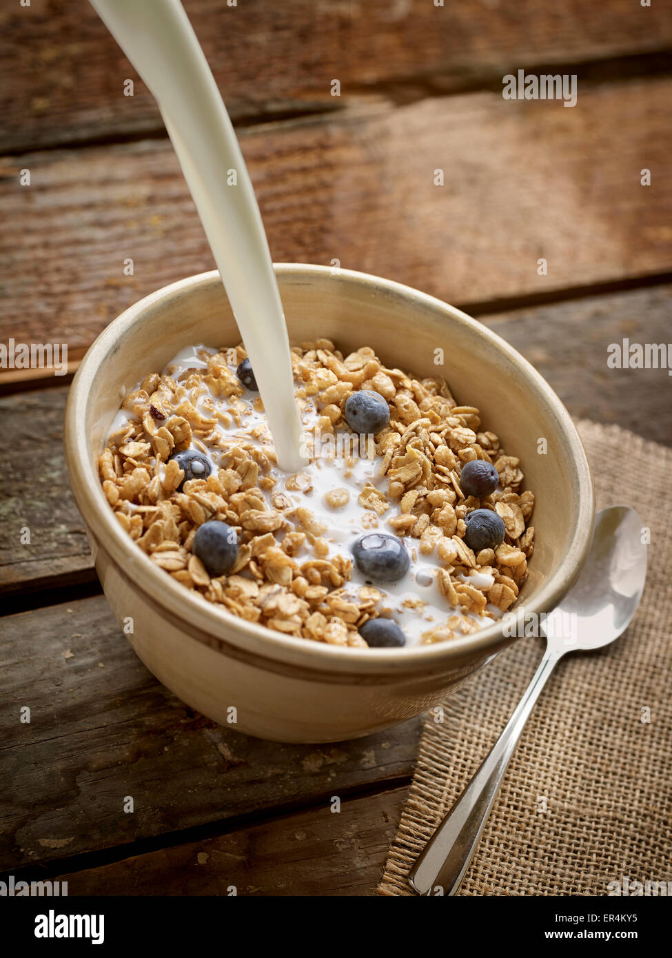 Breakfast Crunchy Cereal Poured in Bowl with Milk or Yogurt in