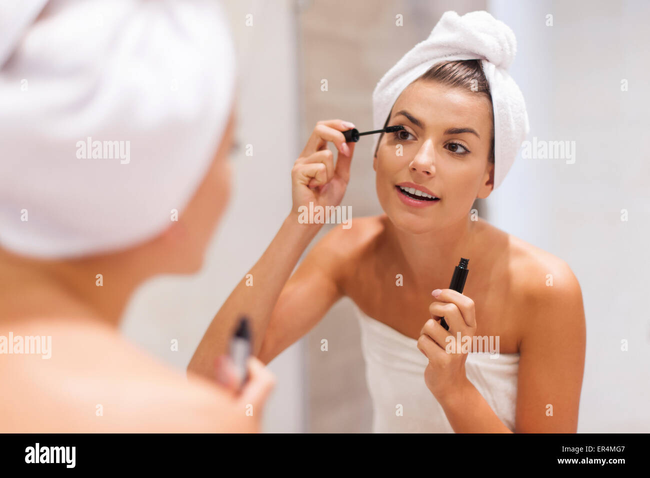 Beautiful woman using mascara in bathroom. Debica, Poland Stock Photo Alamy