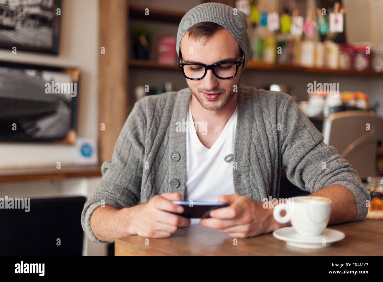 Stylish man enjoying the free internet at cafe. Krakow, Poland Stock Photo