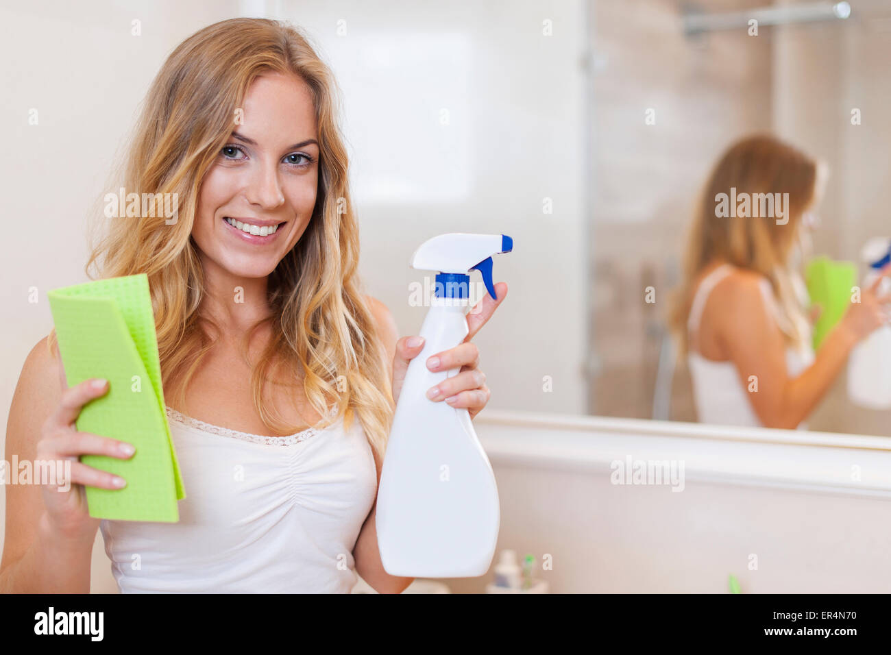 Happy blonde woman is ready to cleaning bathroom. Debica, Poland Stock Photo