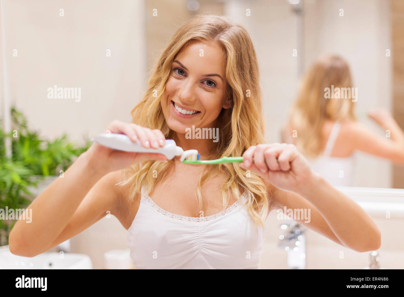 Beautiful blonde woman during morning routine. Debica, Poland Stock Photo
