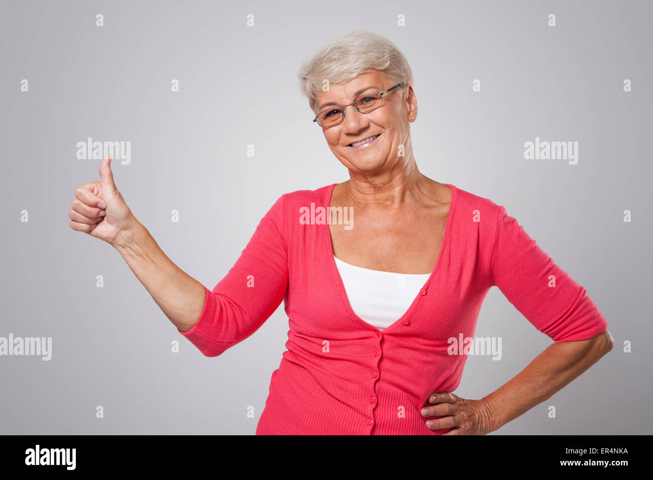 Thumbs up from older lady Stock Photo