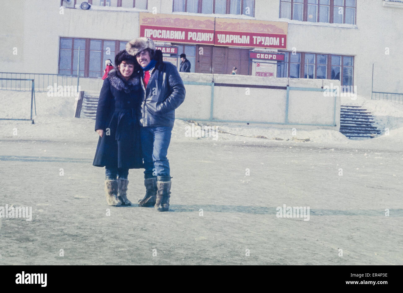 Portrait of happy family pair on a street of settlement Komsomolskiy near Pevek, most northern town in USSR, vintage photo 1986 Stock Photo