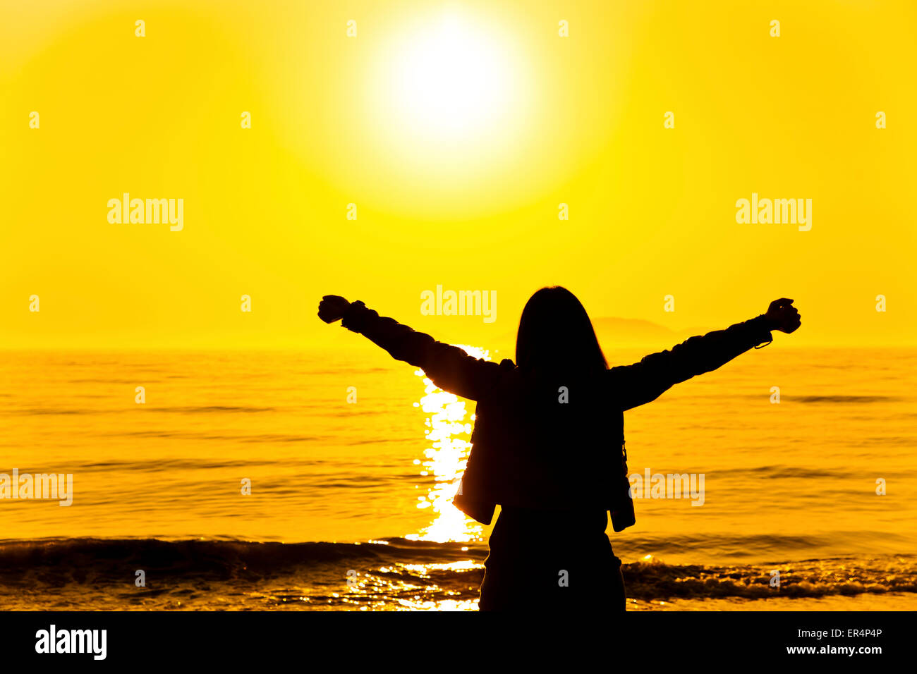 Silhouette of a woman relaxing at sunset Stock Photo - Alamy