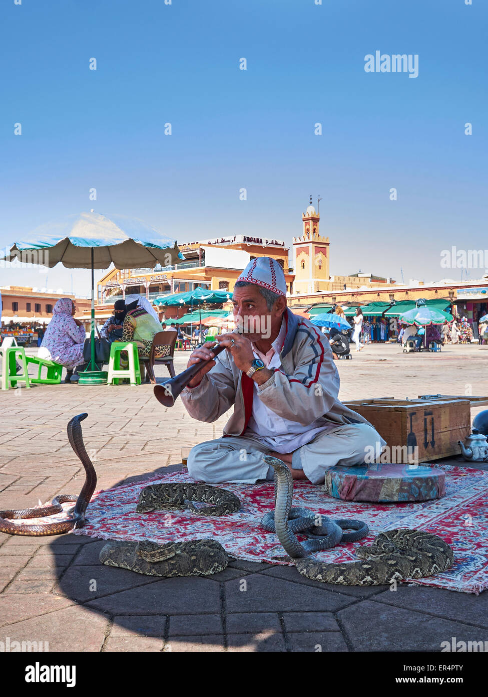 Snake Charmer in the 'Djeema el fnaa'  - The very busy Marrakech market square Stock Photo