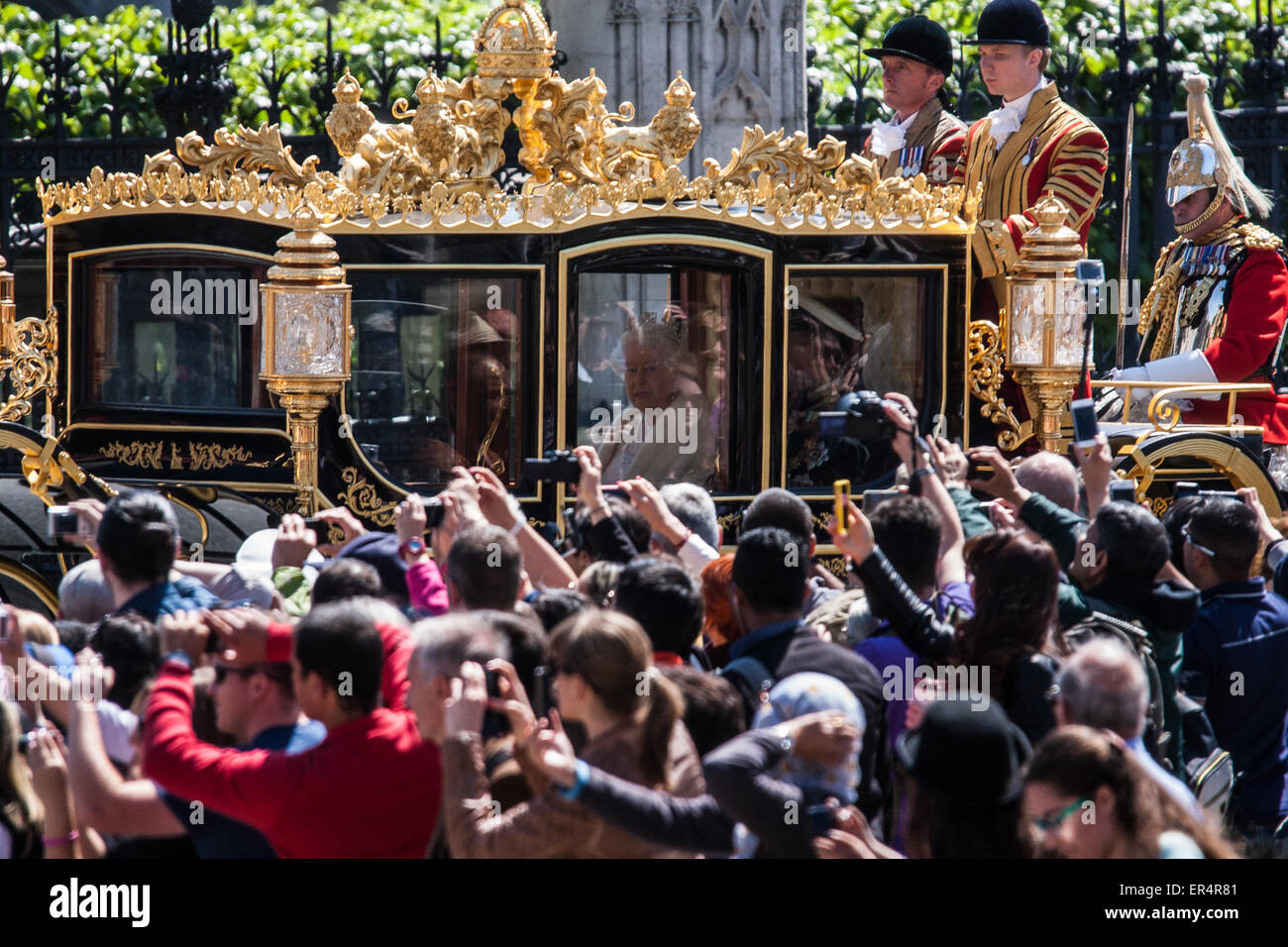 London, UK. 27th May, 2015. The Queen looks out at the crowd as she leaves Parliament in her carriage. Credit: Paul Davey/Alamy Live News Stock Photo
