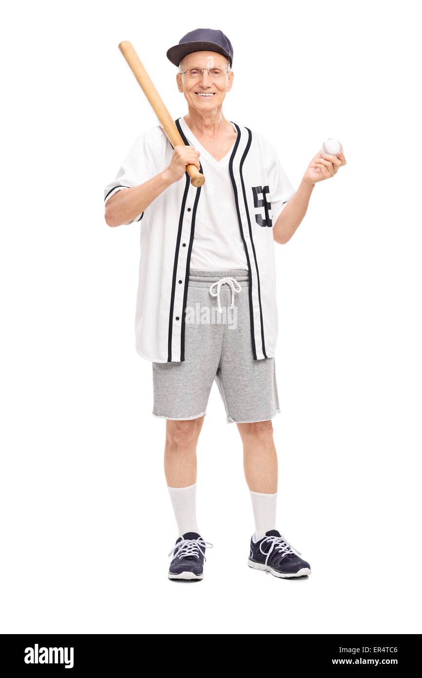 Full length portrait of an active senior in baseball jersey holding a baseball bat and a ball isolated on white background Stock Photo