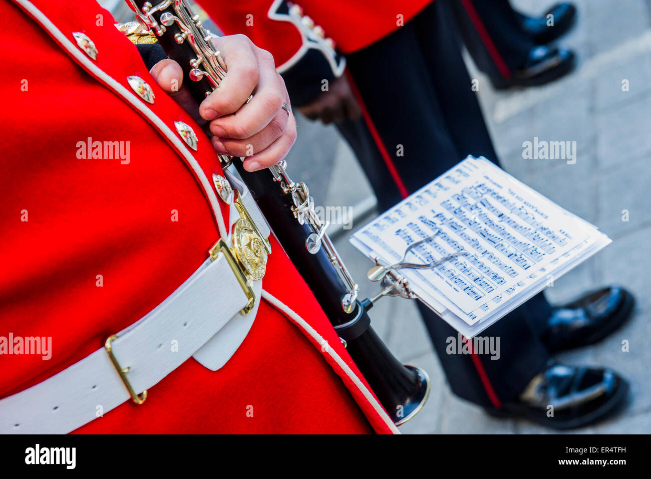 London, UK. 27th May, 2015. A Guards band waits in a side street to play the Royal salute. The Queen, Prince Charles and her crown pass down Whitehall, in carriages of state,  on their return from the State Opening of Parliament. Credit:  Guy Bell/Alamy Live News Stock Photo