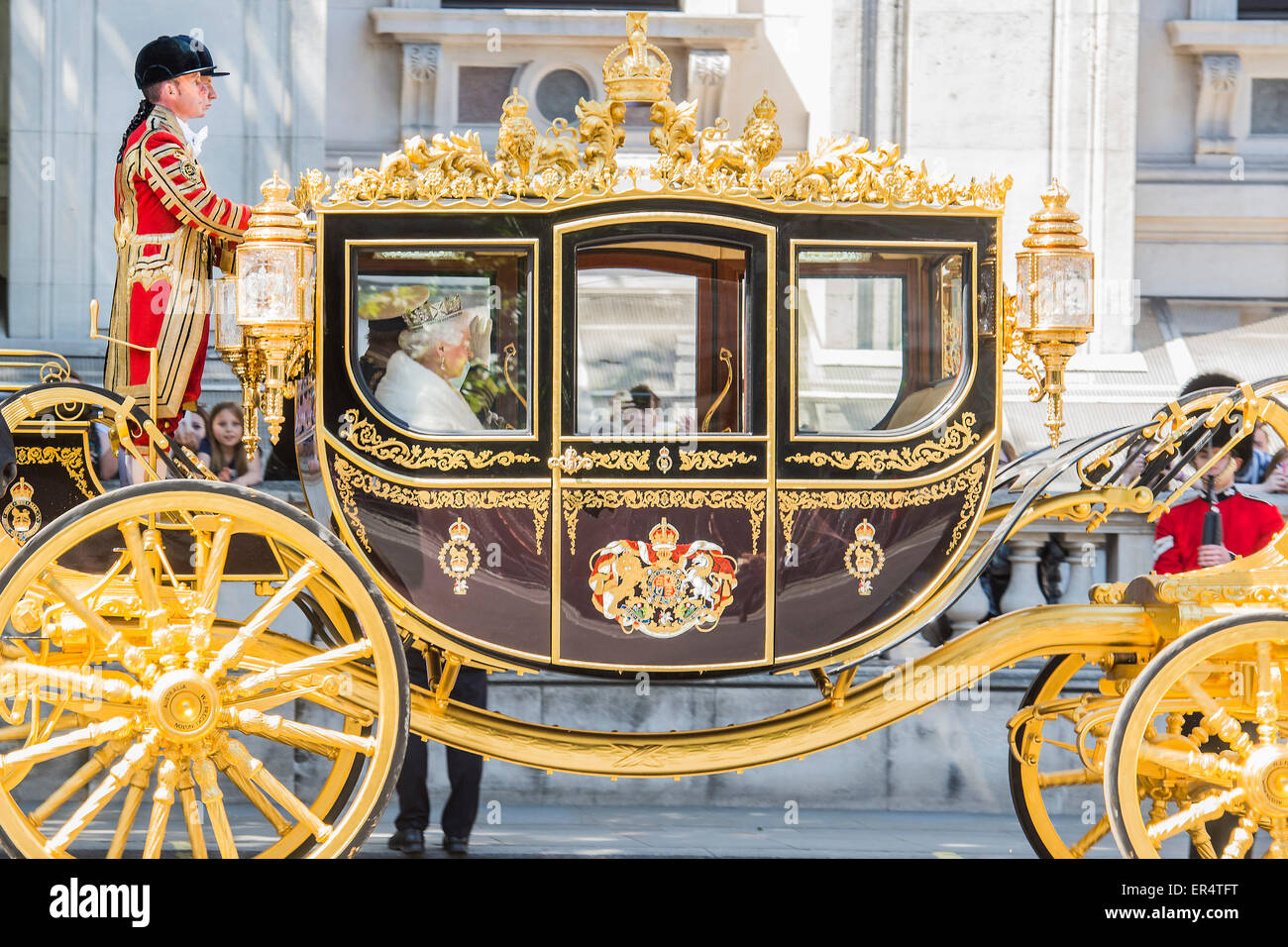 London, UK. 27th May, 2015. The Queen, Prince Charles and her crown pass down Whitehall, in carriages of state,  on their return from the State Opening of Parliament. Credit:  Guy Bell/Alamy Live News Stock Photo