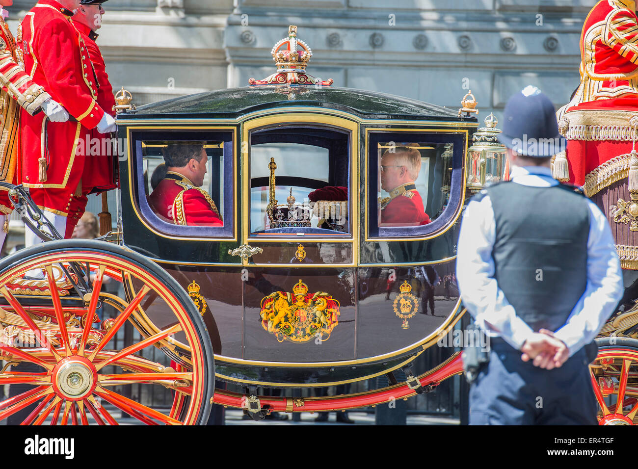 London, UK. 27th May, 2015. The Crown - The Queen, Prince Charles and her crown pass down Whitehall, in carriages of state,  on their return from the State Opening of Parliament. Credit:  Guy Bell/Alamy Live News Stock Photo