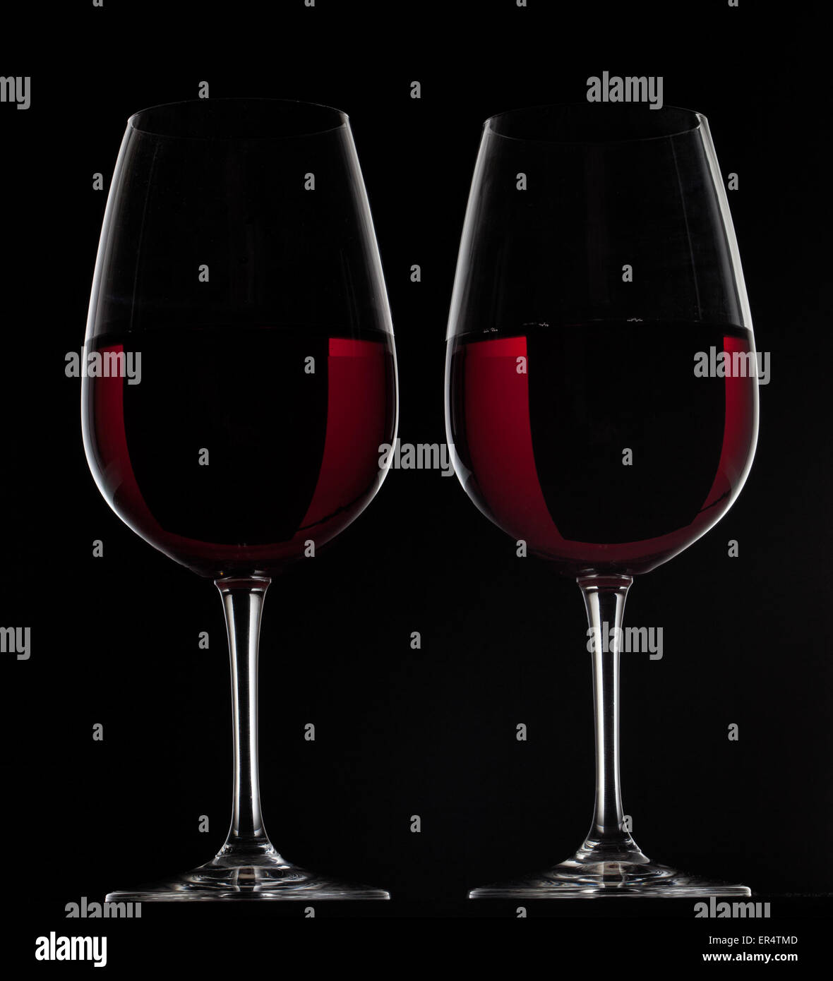 Two red wine glasses with wine on black background Stock Photo Alamy