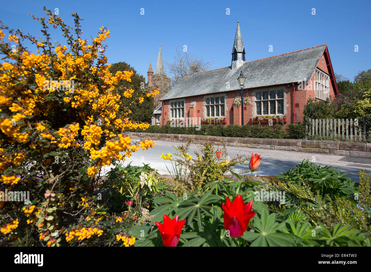 Village of Aldford, England. Picturesque spring view of Aldford Village Hall in Church Lane. Stock Photo