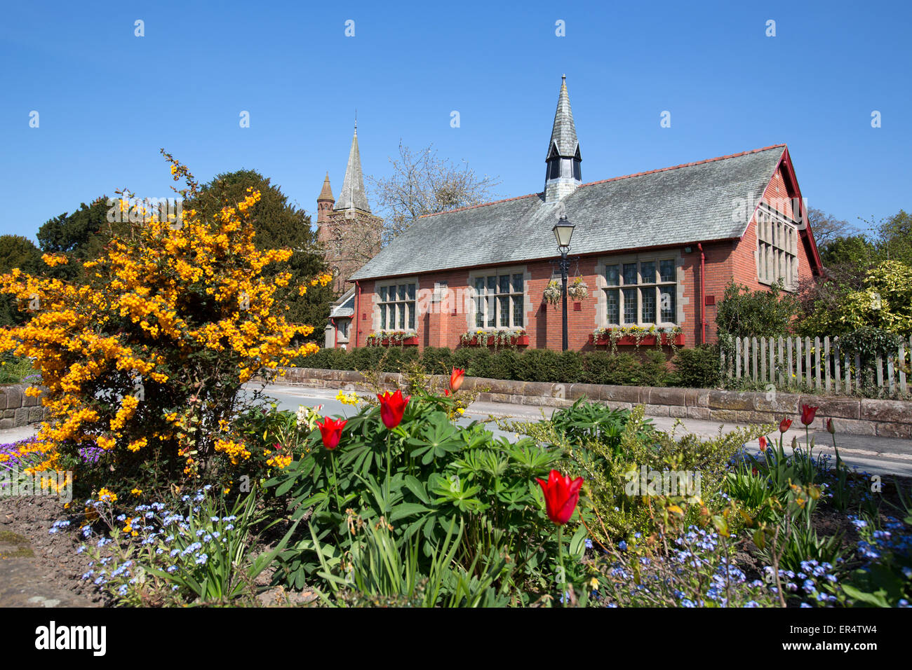 Village of Aldford, England. Picturesque spring view of Aldford Village Hall in Church Lane. Stock Photo