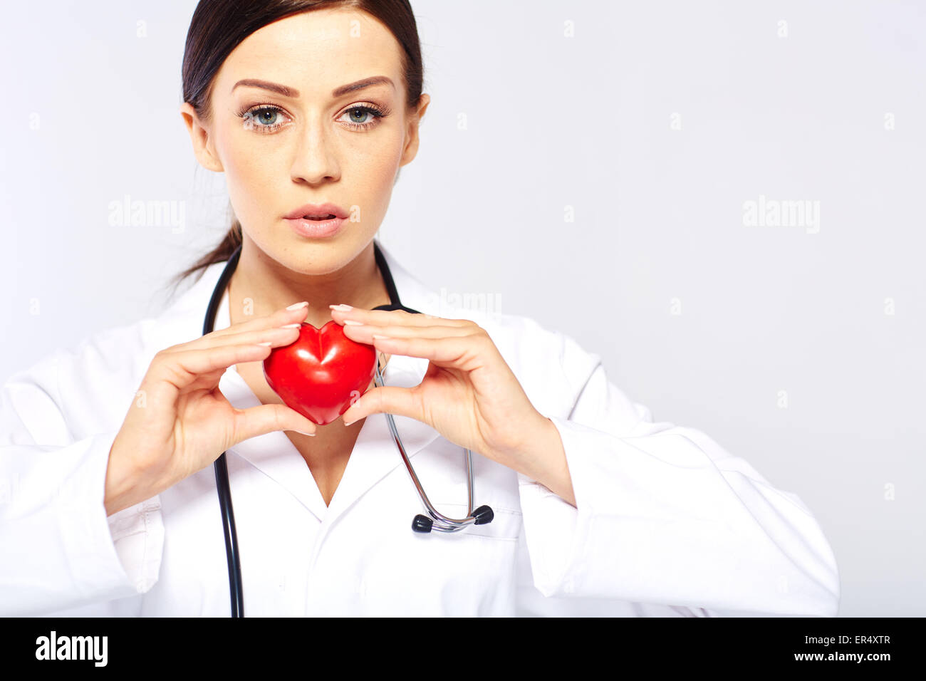 female doctor holding a heart Stock Photo - Alamy