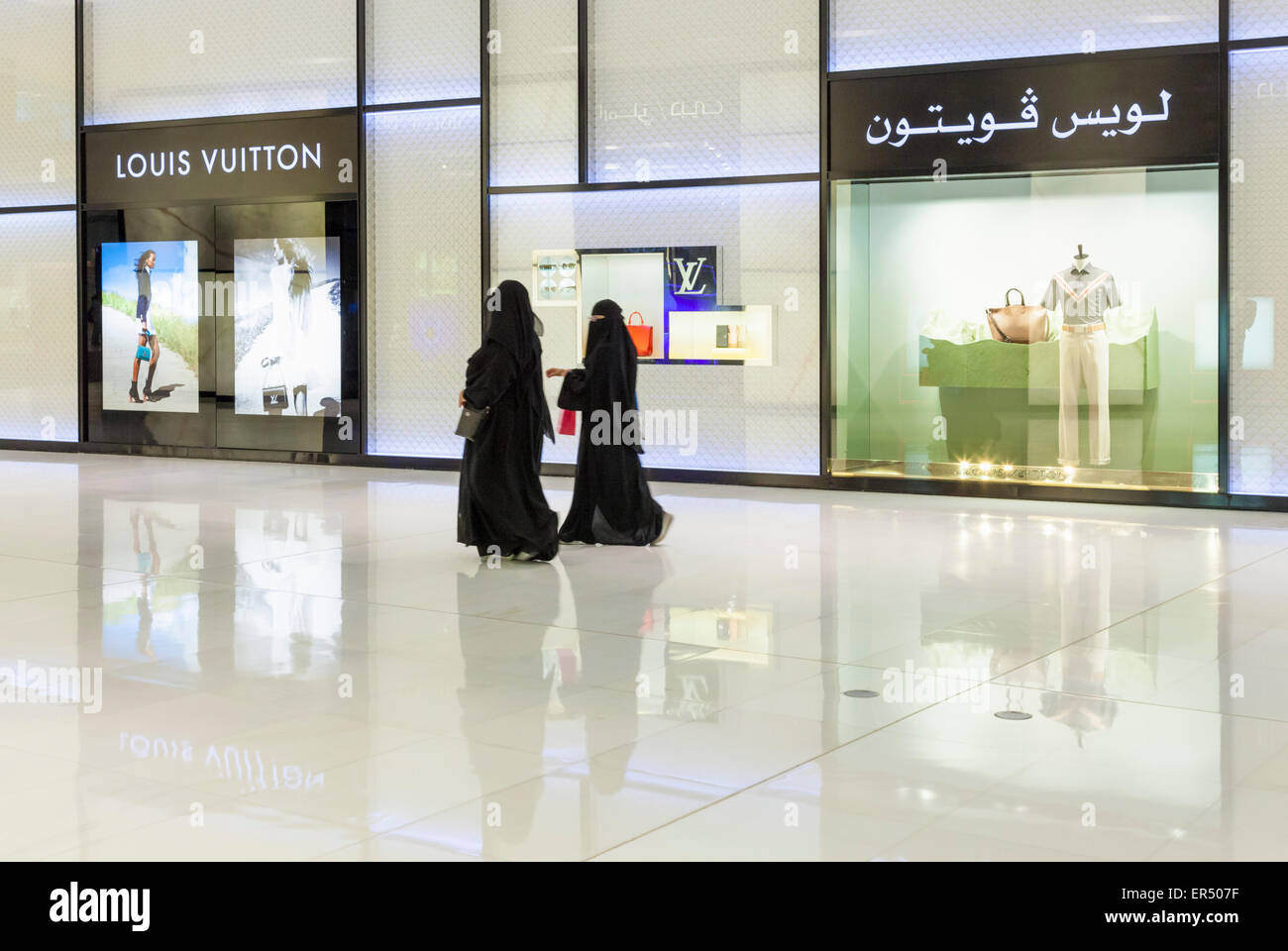 Arab shoppers outside Louis Vuitton store Dubai Mall Dubai City, United Arab Emirates, UAE, Middle East Stock Photo