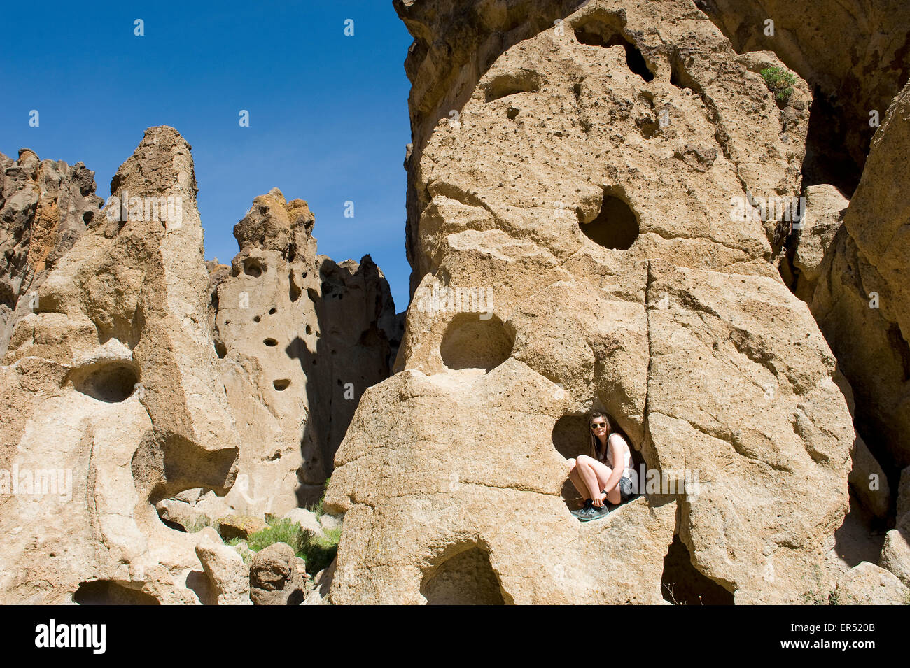 Girl Climbing in Hole in the Wall Canyon, Mojave National Preserve located in the Mojave Desert of California, USA. Stock Photo