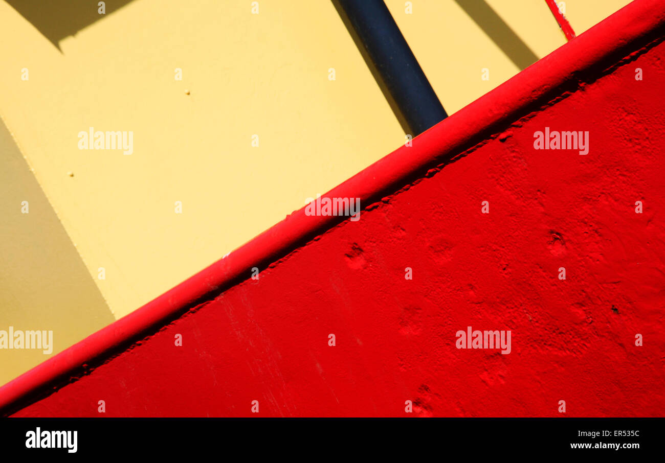 An abstract colour study in yellow and red of an old iron workboat. Stock Photo