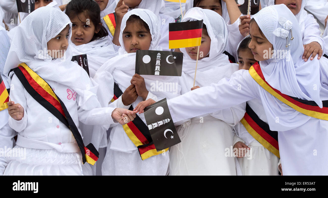 Hanau, Germany. 27th May, 2015. Young girls wearing German sashes and holding flags depicting the Islamic crescent wait for the arrival of the guests of honour during the opening of the new Bait-ul-Wahid mosque of the Ahmadiyya Muslim Jamad denomination in Hanau, Germany, 27 May 2015. The mosque has two 12-metres tall minarets and offers space for up to 500 people. Photo: BORIS ROESSLER/dpa/Alamy Live News Stock Photo