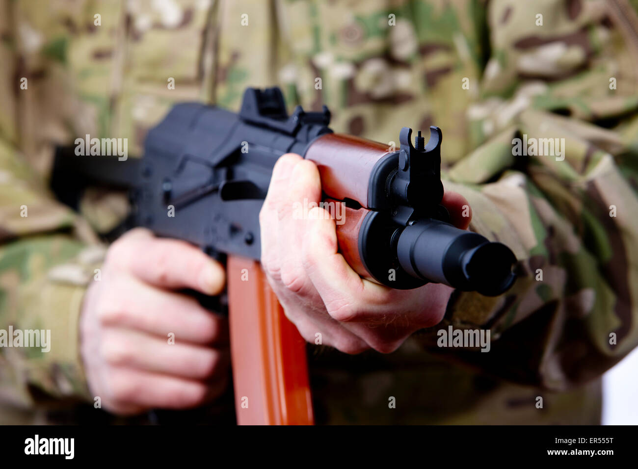 man in combat fatigues holding aks-47u close quarter combat kalashnikov rifle Stock Photo
