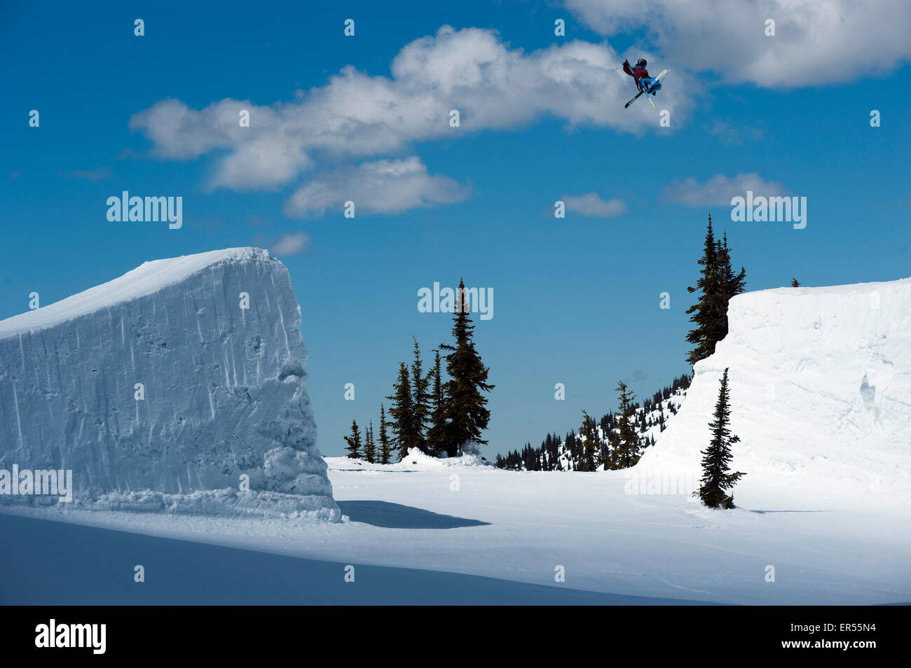 A snowboarder clears a gap jump in British Columbia Stock Photo Alamy