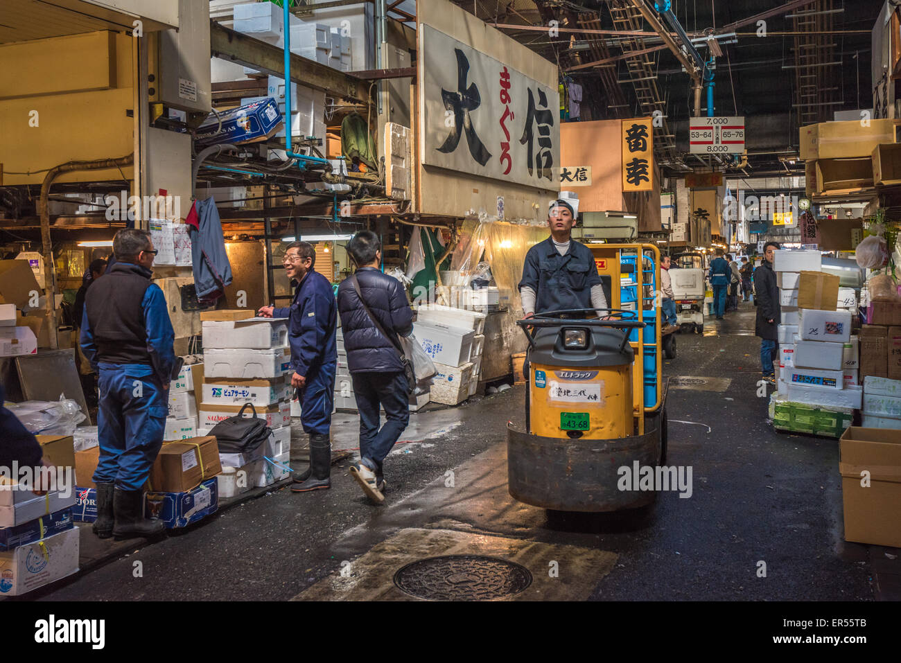 TOKYO, JAPAN - November, 22, 2014: A man driving taretto, motorized cargo cart, at , the biggest fish and seafood market in the Stock Photo