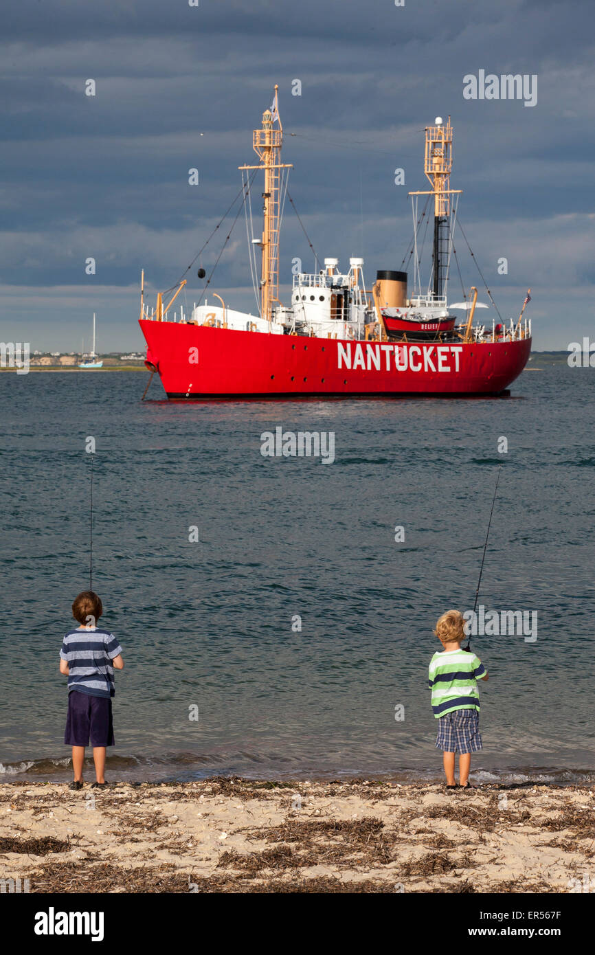boys fishing at Brant Point Lighthouse, Nantucket Stock Photo