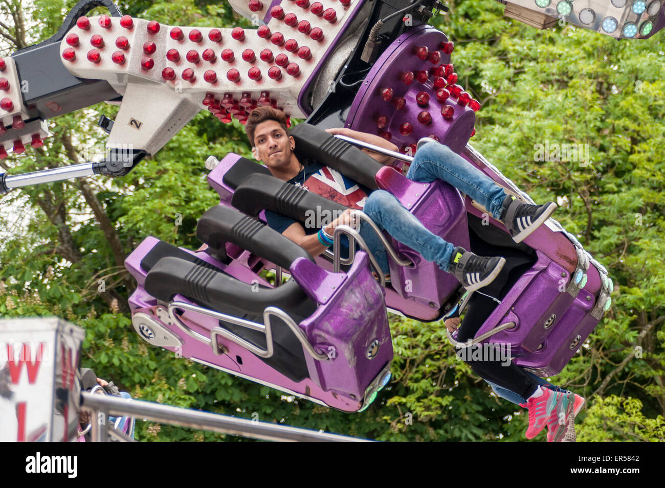 Pinner, London, UK. 27 May 2015. A customer on an aerial spinning ride