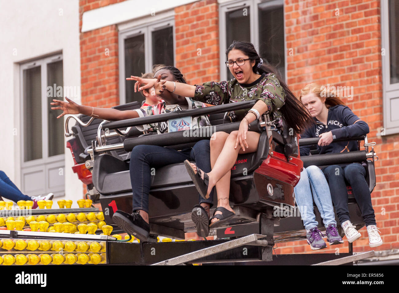 Pinner, London, UK. 27 May 2015. Children enjoy a spinning ride, as