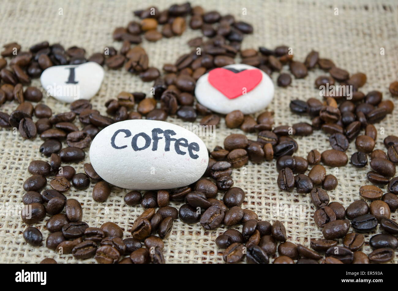 Roasted coffee beans with a 'I love coffee' message on a vintage tablecloth Stock Photo