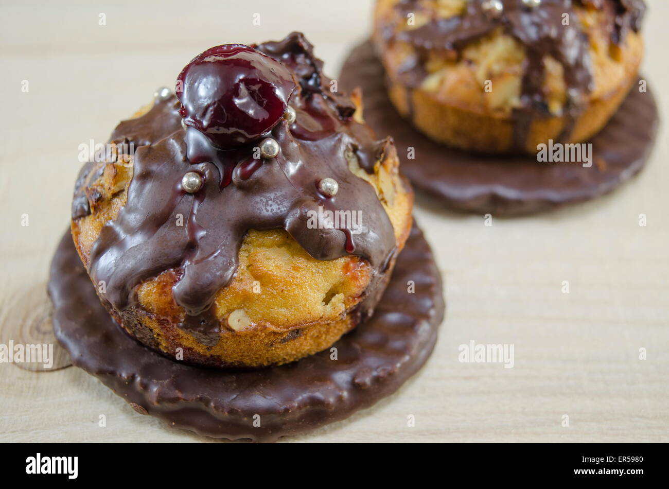 Homemade donuts glazed with chocolate with a cherry on top Stock Photo