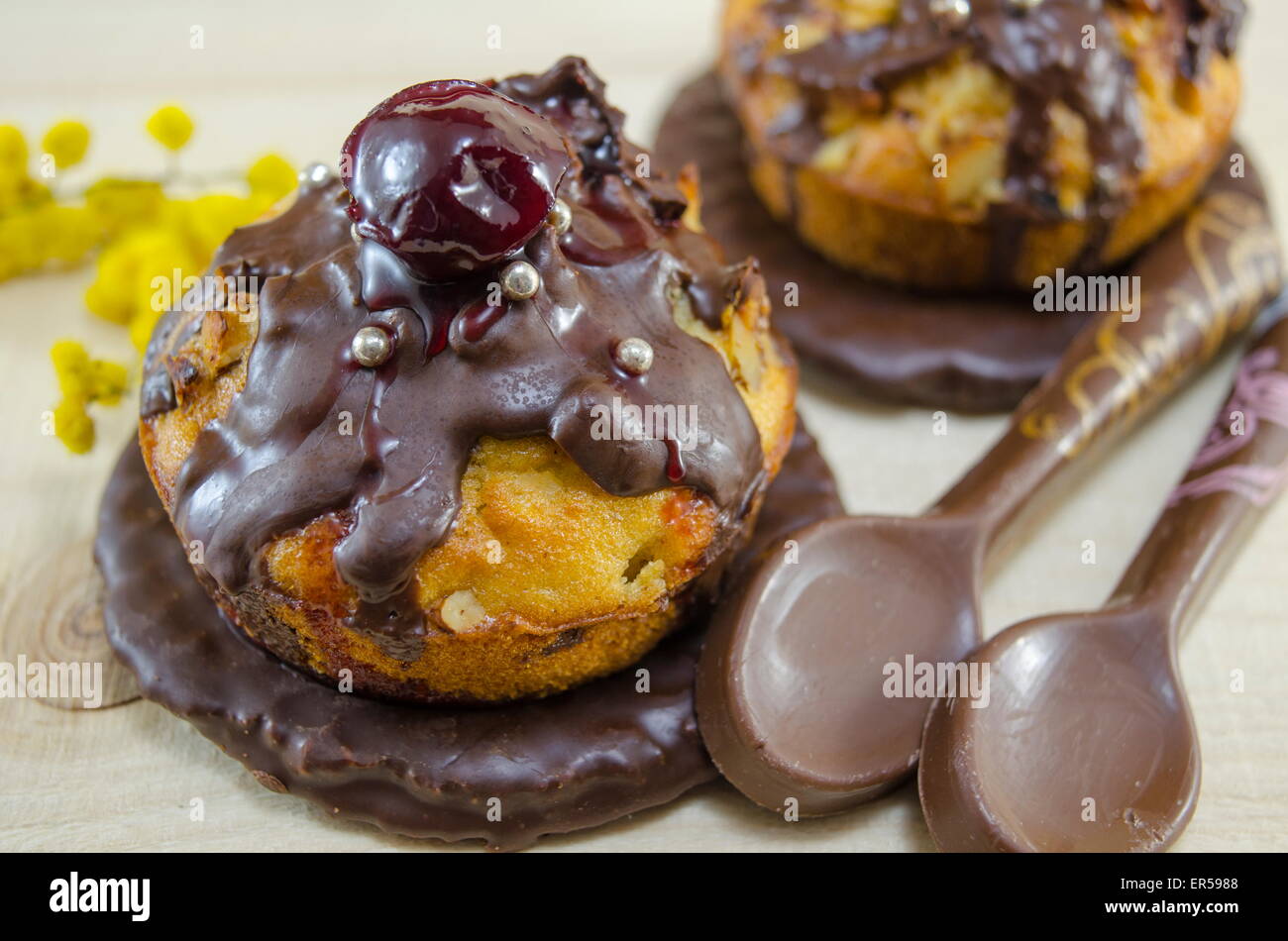 Homemade donuts glazed with chocolate with a cherry on top Stock Photo