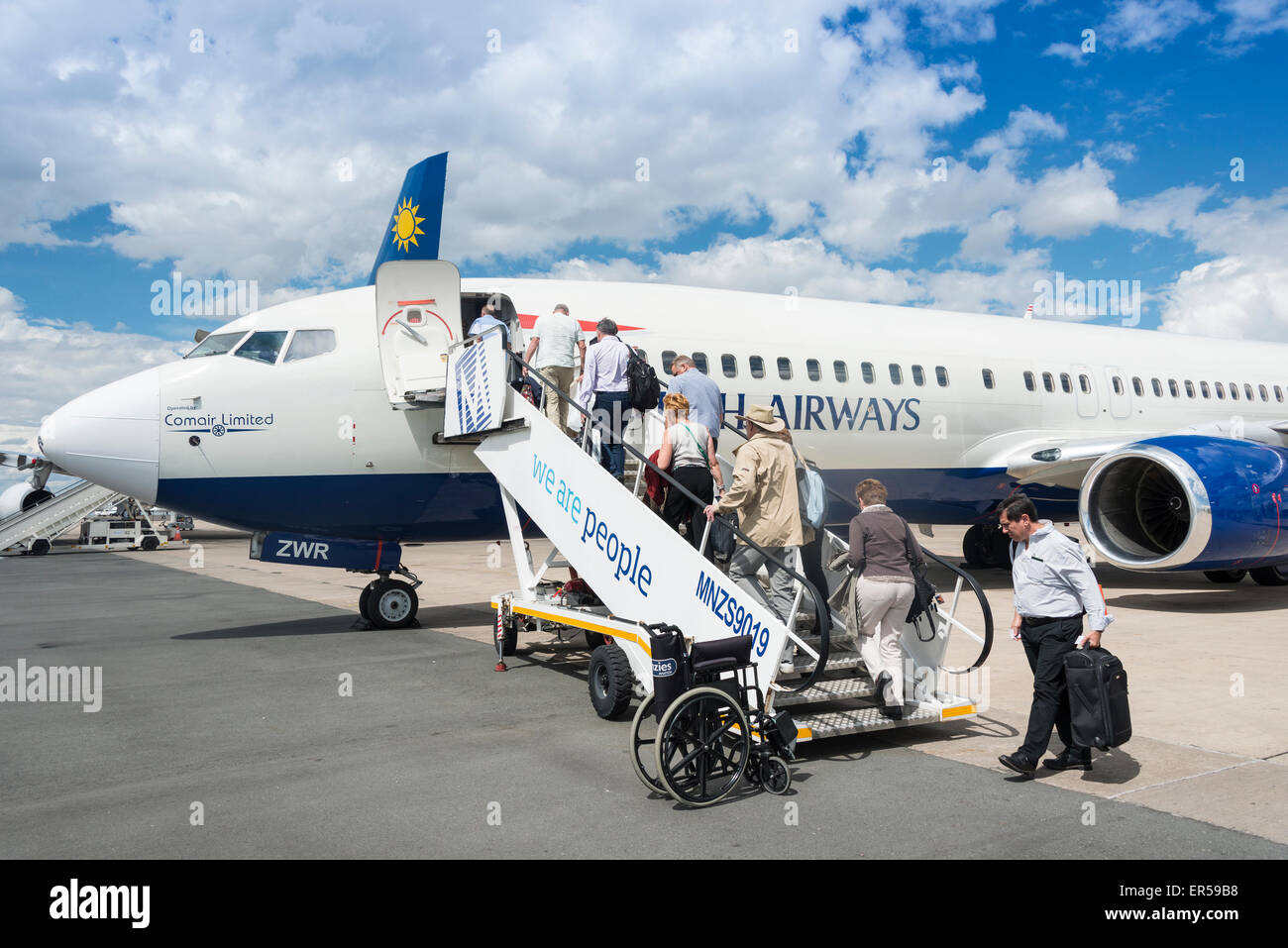 Passengers boarding British Airways (Comair) Boeing 737 at Hosea Kutako International Airport, Windhoek, Republic of Namibia Stock Photo