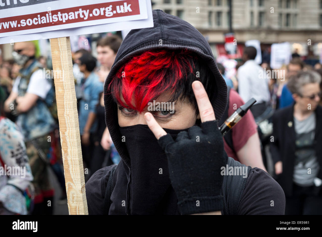 London, UK. 27th May, 2015. A demonstrator poses in central London during an evening of protest against public sector spending cuts imposed by Britain's Conservative Party in the years since the party, known also as the Tories, came to power in 2010. The evening's protests were held on the day of the State Opening of Parliament, with spending cuts set to continue—and, many fear, deepen—following the Conservatives' surprise majority win in Britain's recent general election. Credit: David Cliff/Alamy Live News Stock Photo