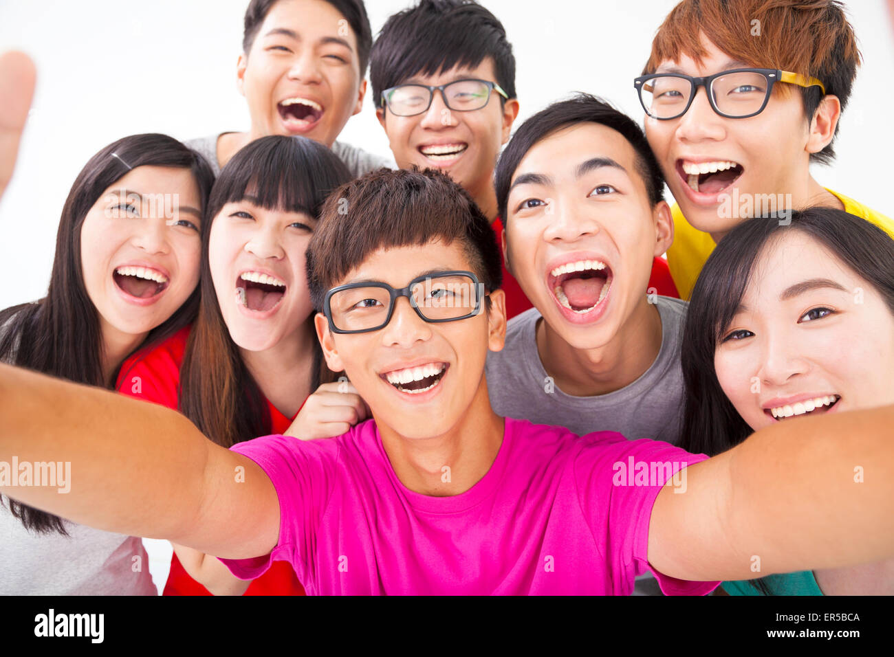 group of smiling friends with camera  taking self photo Stock Photo