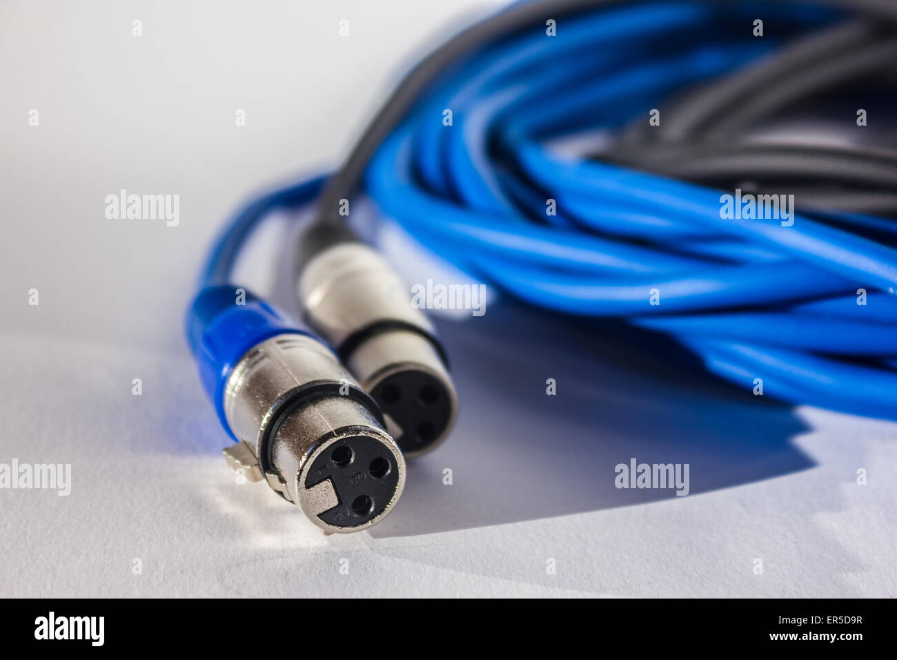 XLR cables and connections details. Poster background blue Stock Photo
