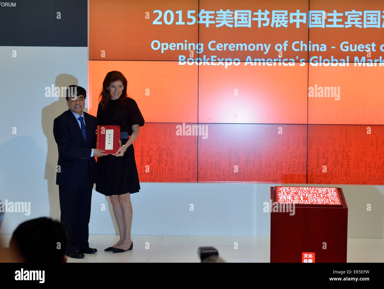 (150527) -- NEW YORK, May 27, 2015 (Xinhua) -- Wu Shangzhi(L), vice minister of China's State Administration of Press, Publication, Radio, Film and Television, gives a book as gifts to Linda Johnson, the President & CEO of Brooklyn Public Library during the opening ceremony of China-Guest of Honor 2015 BookExpo America's Global Market Forum in New York, the United States, on May 27, 2015. Bringing in nearly 10,000 book titles from some 150 publishers, China came under the spotlight in this "publishing and cultural capital of the world" as BookExpo America (BEA) 2015 kicked off in New York City Stock Photo
