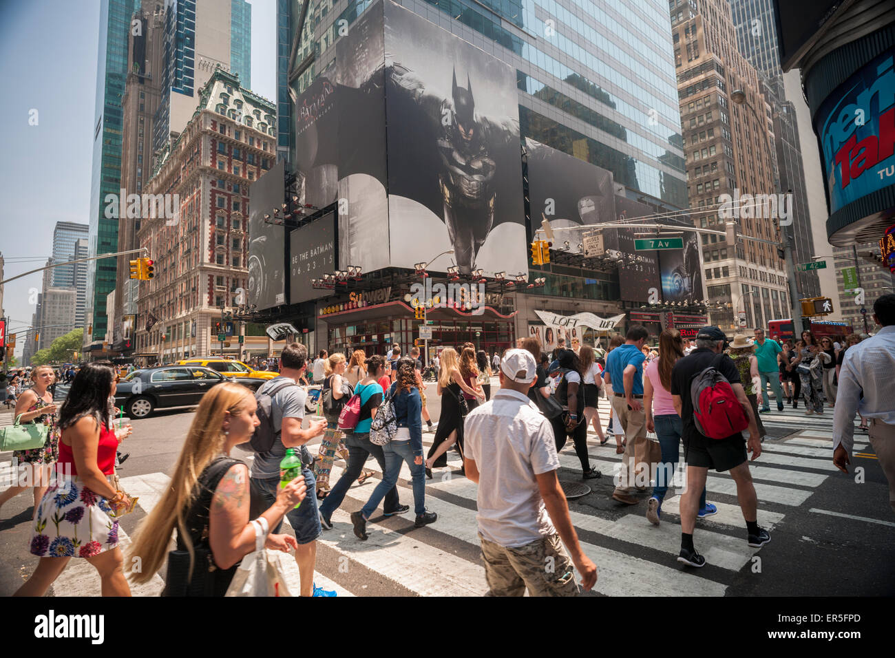 Passerby walk past advertising for RocksteadyStudio's new videogame, 'Batman: Arkham Knight ' on a billboard in Times Square in New York on Wednesday, May 27, 2015. The game, the third part of the 'Arkham' trilogy will be available on June 23. (© Richard B. Levine) Stock Photo