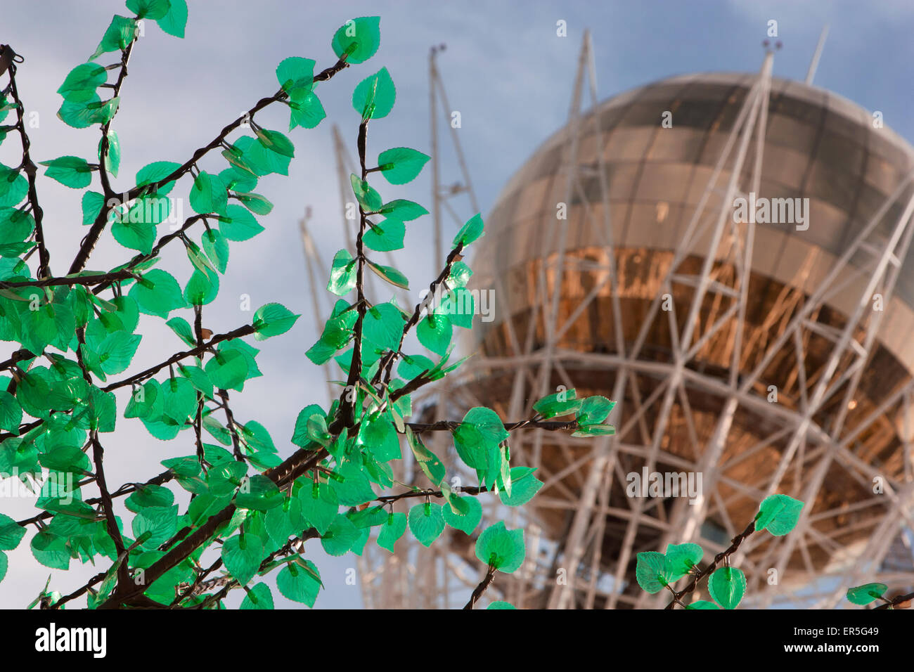 Bayterek Tower in Astana, Kazakhstan, with a blue sky in the background and false leaves in the foreground. Stock Photo