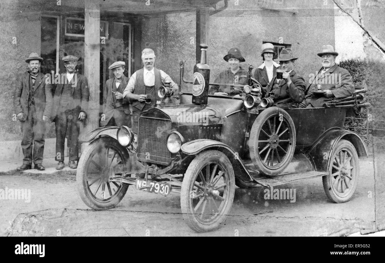 Publican and customers outside pub, with a Bass Brewery car Stock Photo
