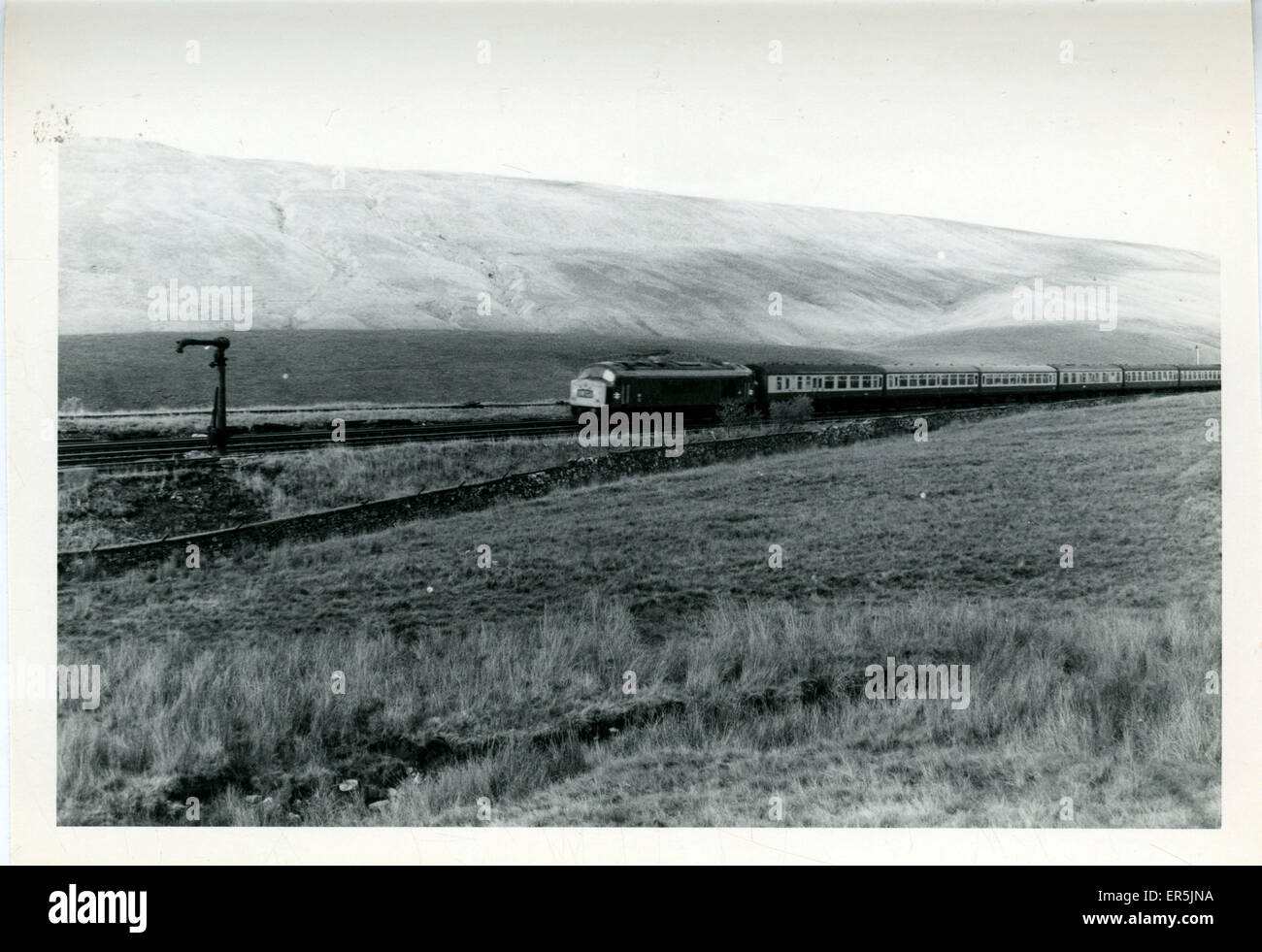 Settle-Carlisle Railway - Water Crane & Passenger Train, Ble Stock Photo