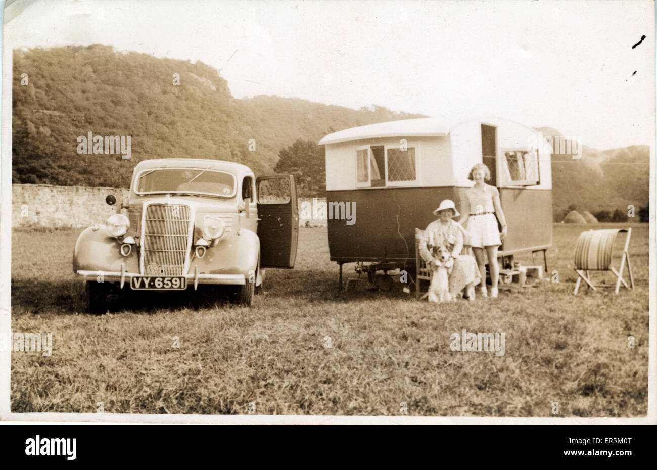 1935 Ford Four-door Sedan Vintage Car with Caravan, England. York registration.  1930s Stock Photo