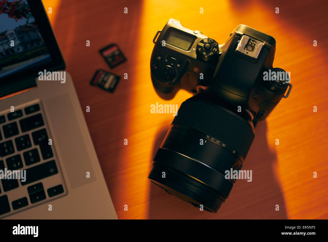 Still life of dslr camera, sdhc flash memories and laptop computer on ...