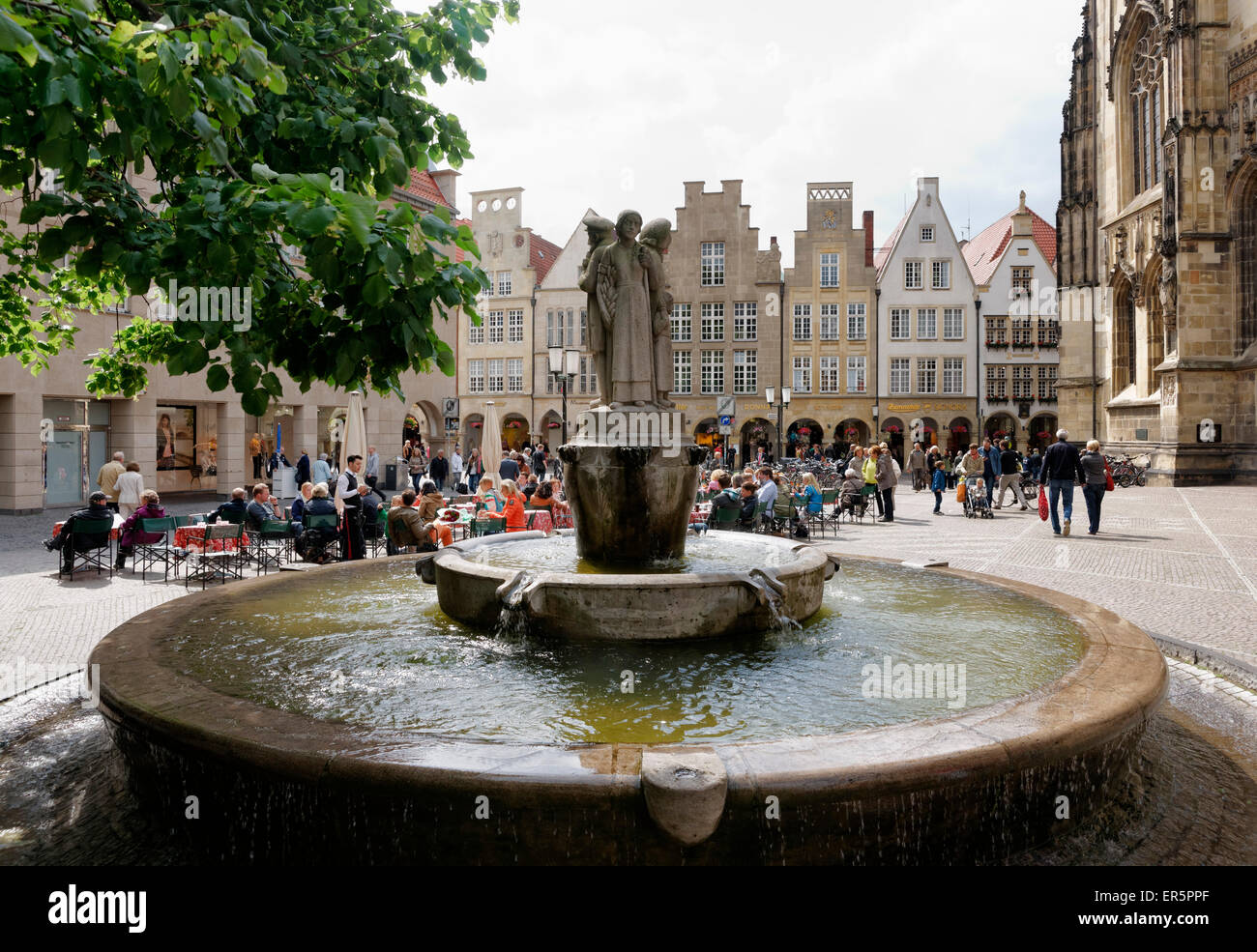 Town square with fountain, Lambertikirchplatz, Muenster, North Rhine-Westphalia, Germany Stock Photo