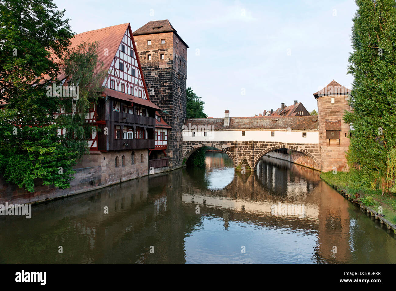 View of max bridge, the river Pegnitz, half-timbered building of the Weinstadel, water-tower and Henkersteg footbridge, Nurember Stock Photo