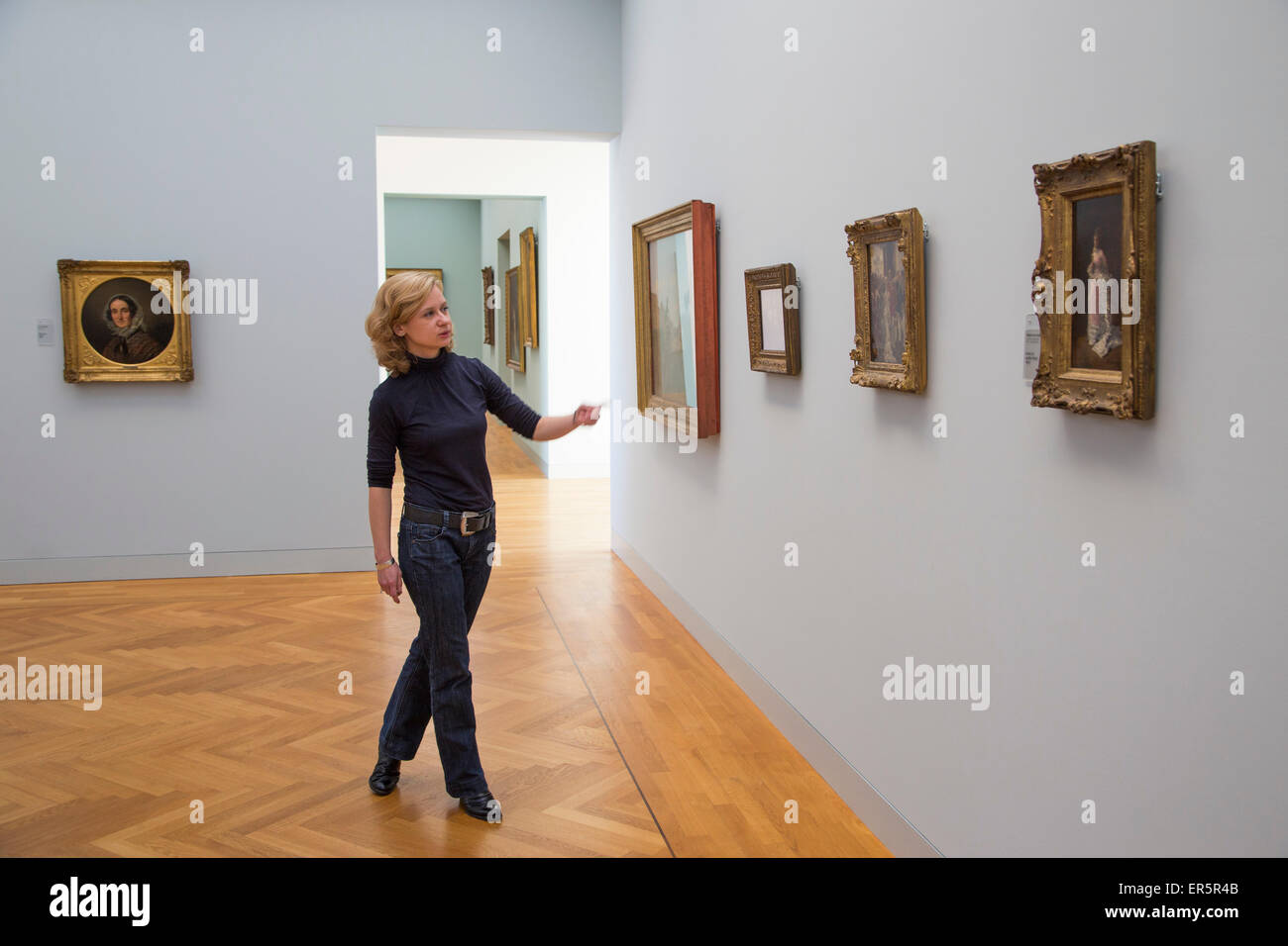 Woman explaining artwork in the Georg Schaefer Museum, Schweinfurt, Franconia, Bavaria, Germany Stock Photo