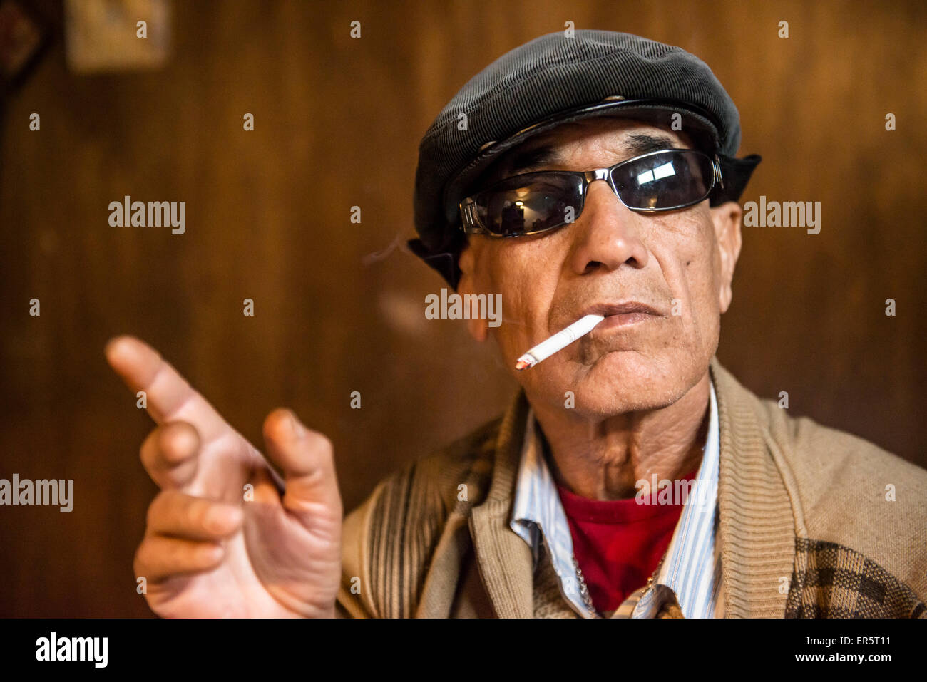 Man wearing sunglasses and smoking a cigarette, Amman, Jordan, Middle East Stock Photo