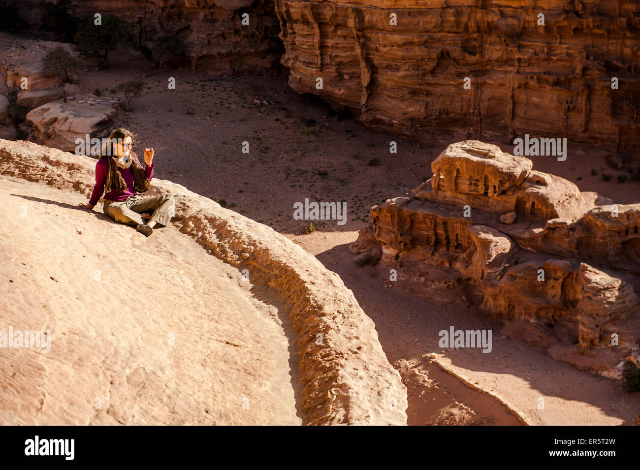 Woman on the roof of Ad Deir, Petra, Jordan, Middle East Stock Photo