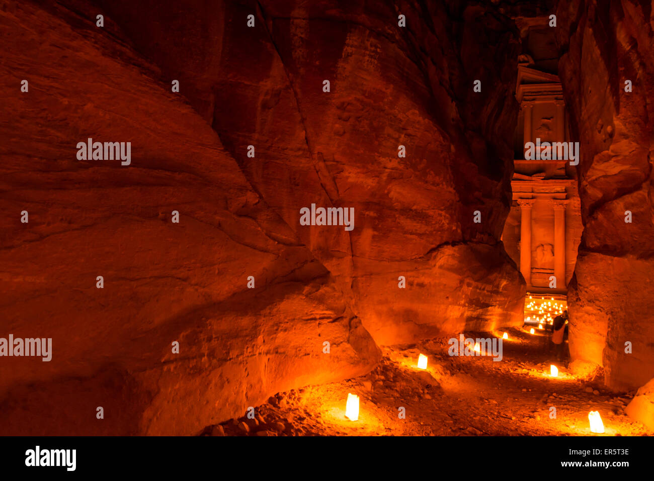View through The Siq to Al Khazneh at night, Petra, Jordan, Middle East Stock Photo