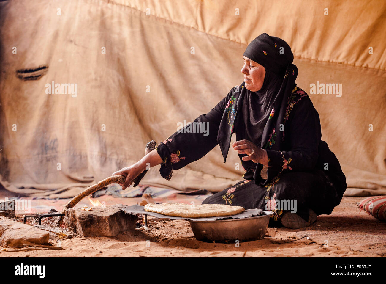 Bedouin woman baking bread, Wadi Rum, Jordan, Middle East Stock Photo